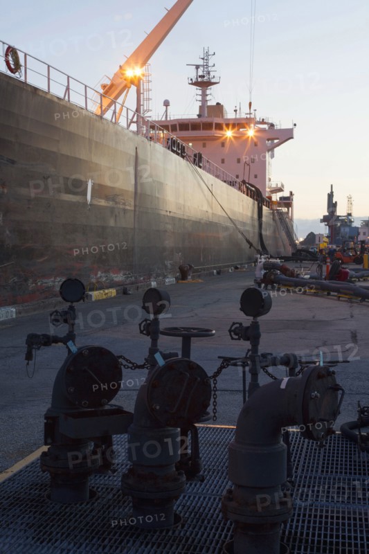 Oil tanker ship docked in industrial harbor