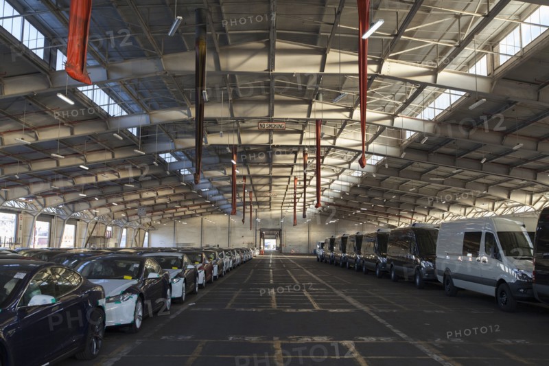 New cars and vans in warehouse