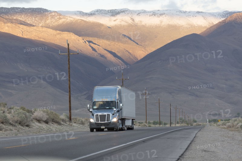 Semi-truck driving on mountain road