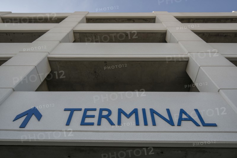 Arrow and terminal sign on parking garage