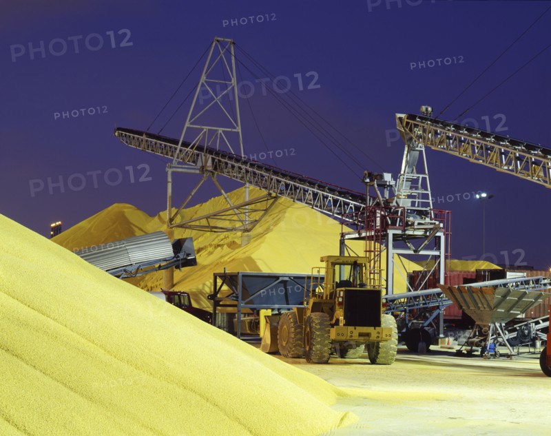 Bulldozer near piles of grain