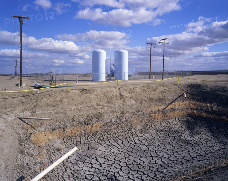 Dry drainage ditch near silos
