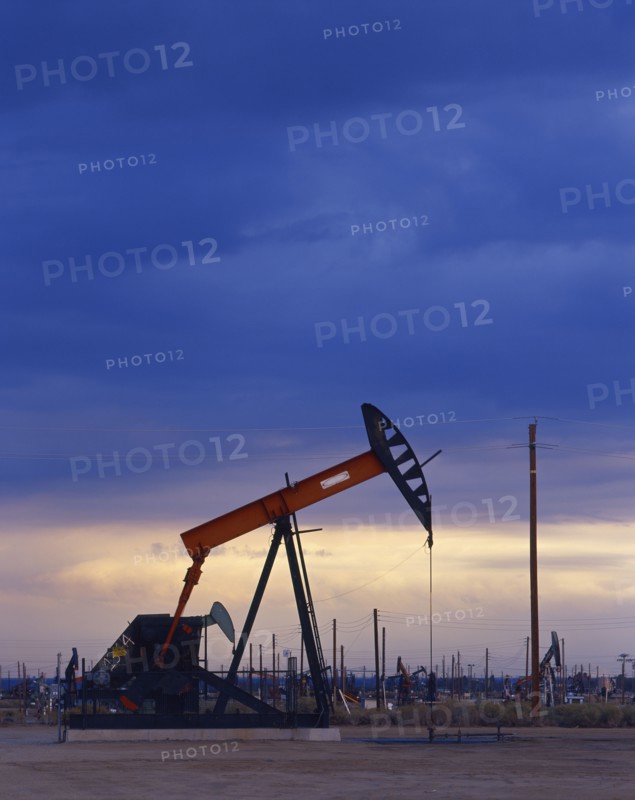 Oil rig drilling at sunset