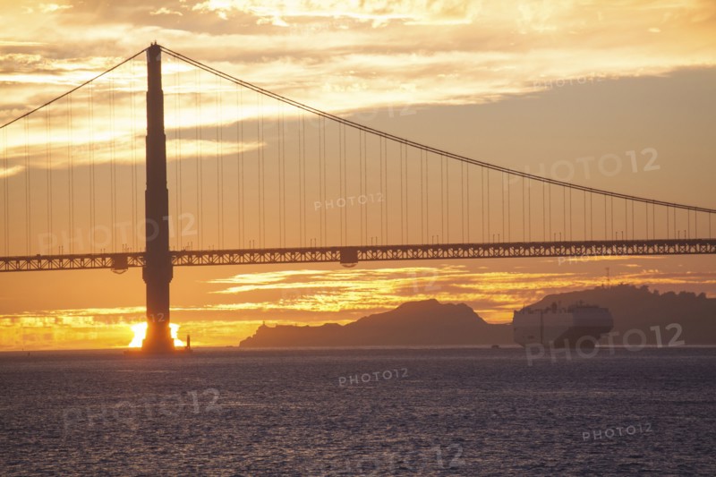 Silhouette of bridge over water at sunset