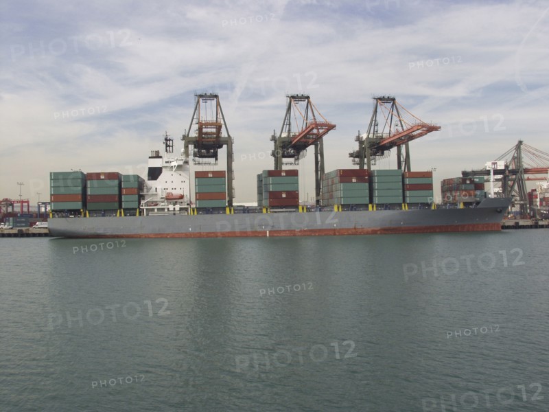 Cranes above cargo containers on freighter