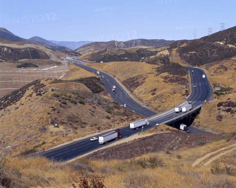 Trucks and cars driving on freeway overpass