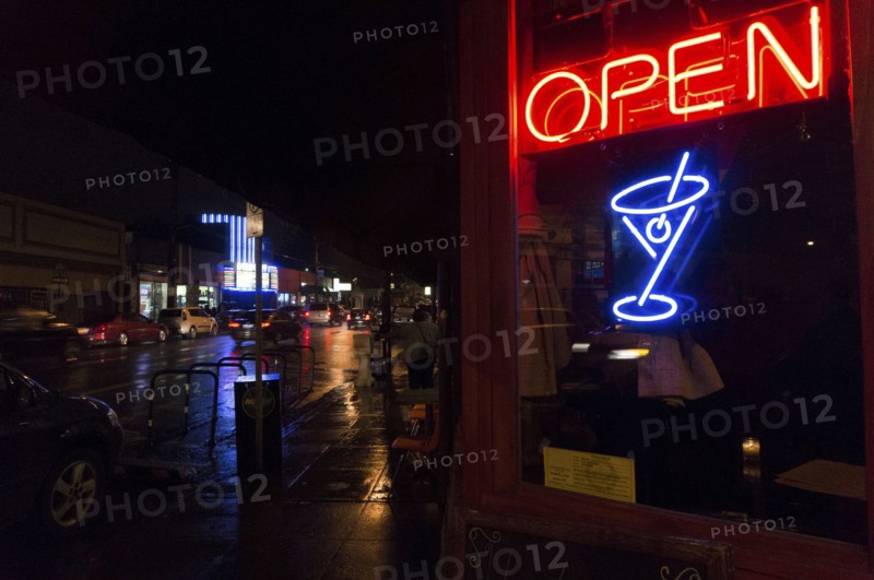Neon sign in bar window at night