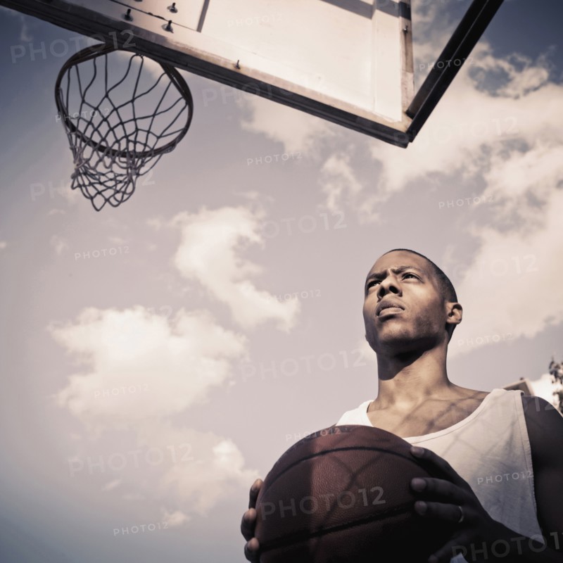 African American man playing basketball on court
