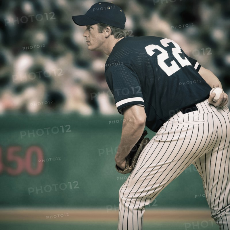 Caucasian baseball player ready to throw ball