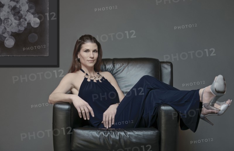 Mixed race woman in evening gown laying in armchair