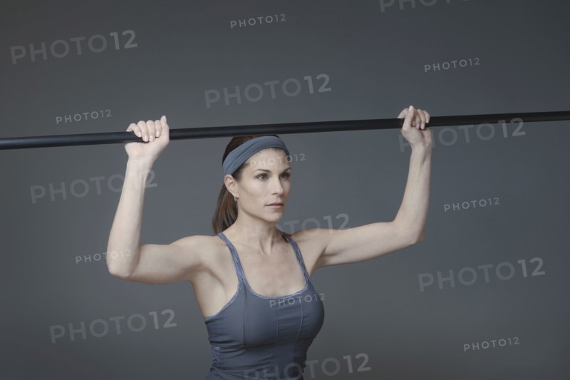 Mixed race woman lifting weights