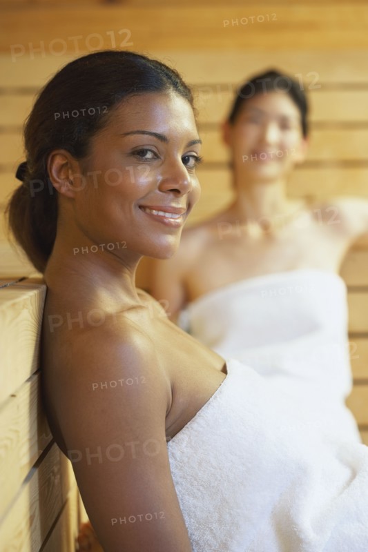 Two multi-ethnic women relaxing in sauna