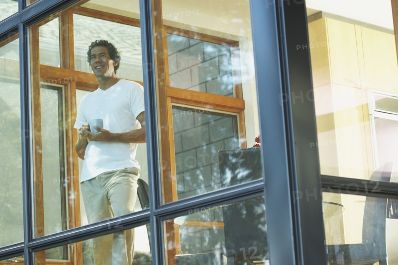 Man looking through window