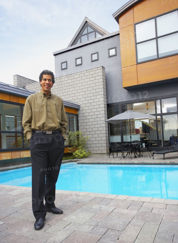 Man standing on patio of house