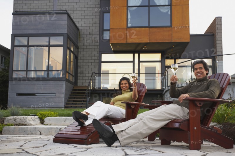 Couple toasting in deck chairs