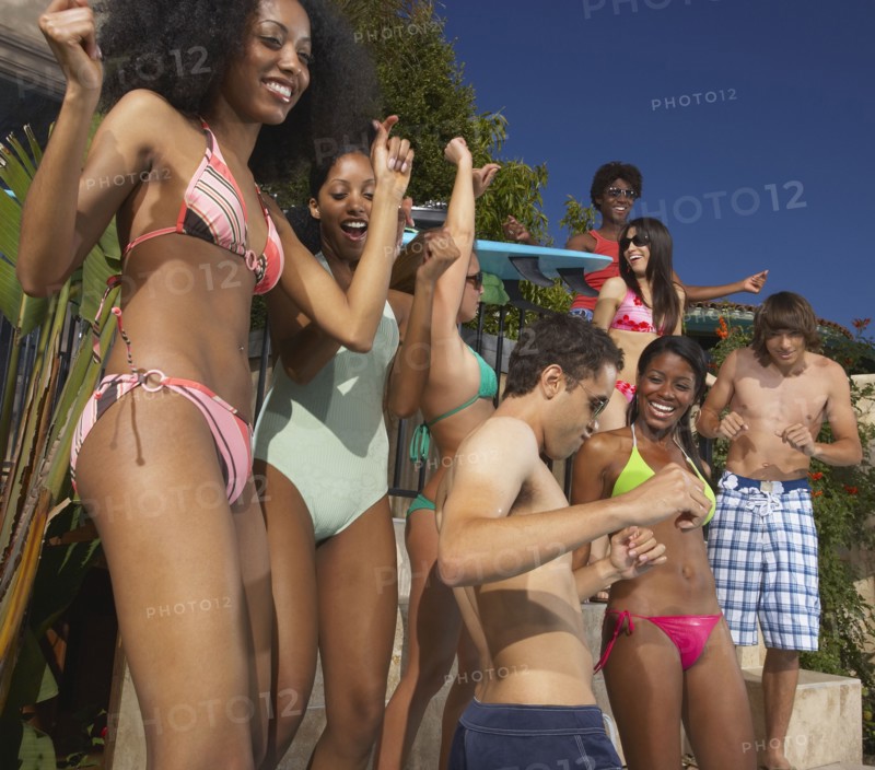 Multi-ethnic group of friends enjoying pool party