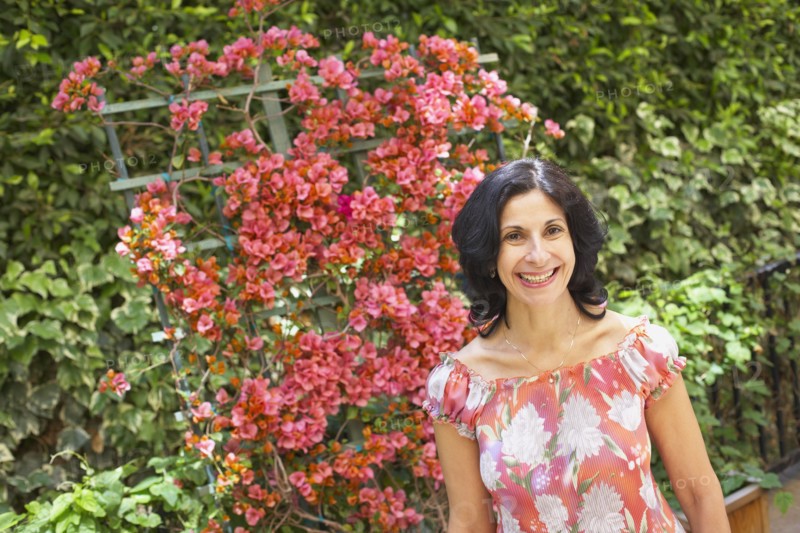 Confident Middle Eastern woman standing in garden