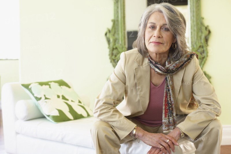 Confident woman sitting in living room