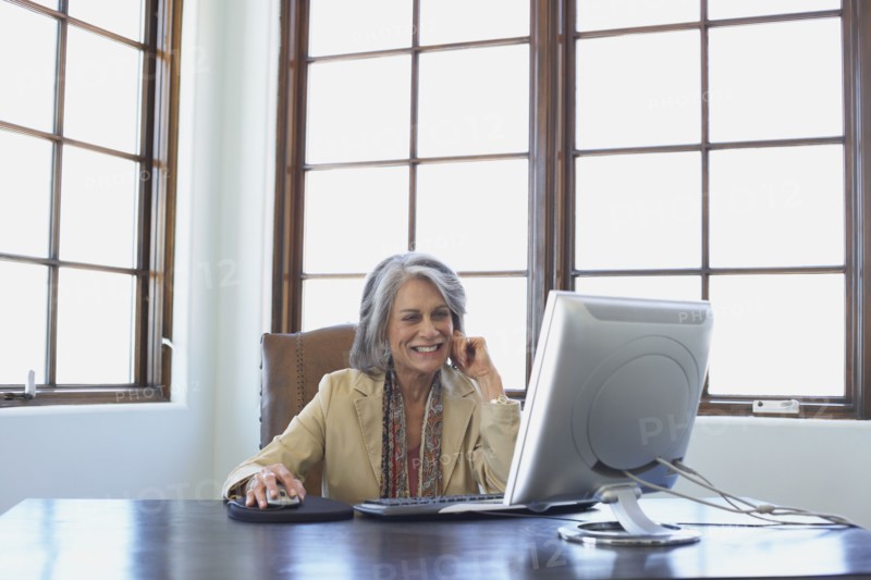 Confident businesswoman working on computer at desk