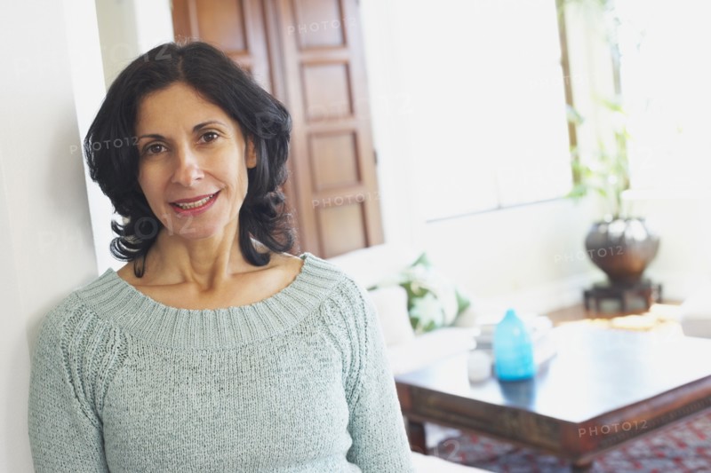 Confident Middle Eastern woman in living room