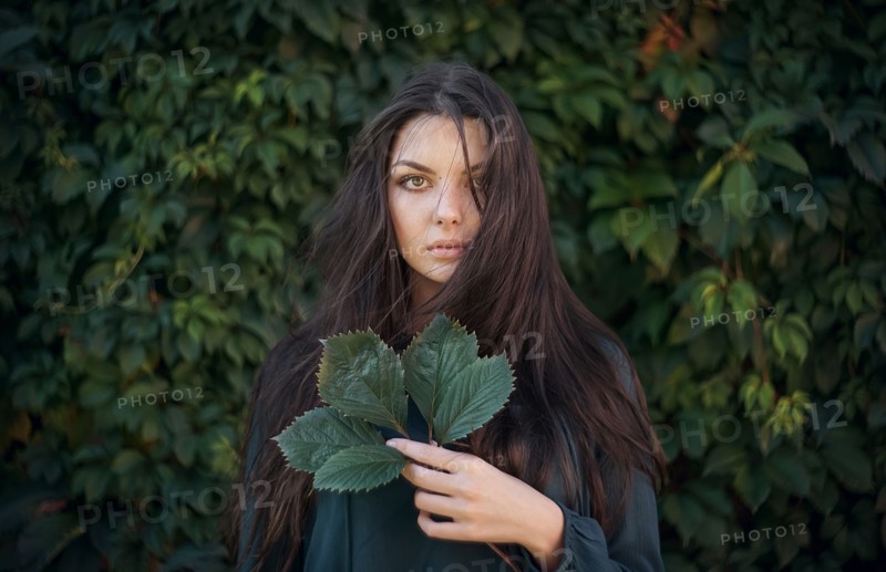 Caucasian woman holding leaves