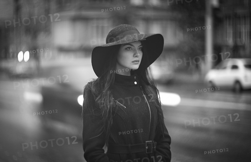 Caucasian woman wearing hat and coat in city