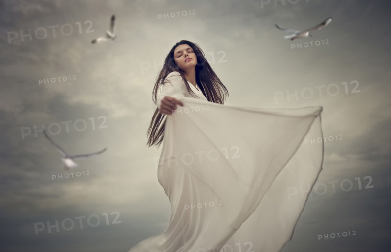 Birds flying near dancing Caucasian woman
