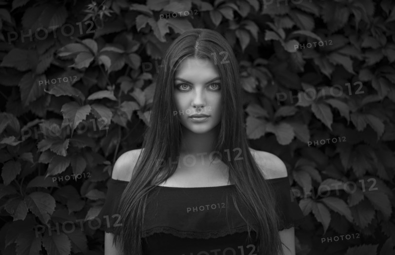 Caucasian woman near foliage