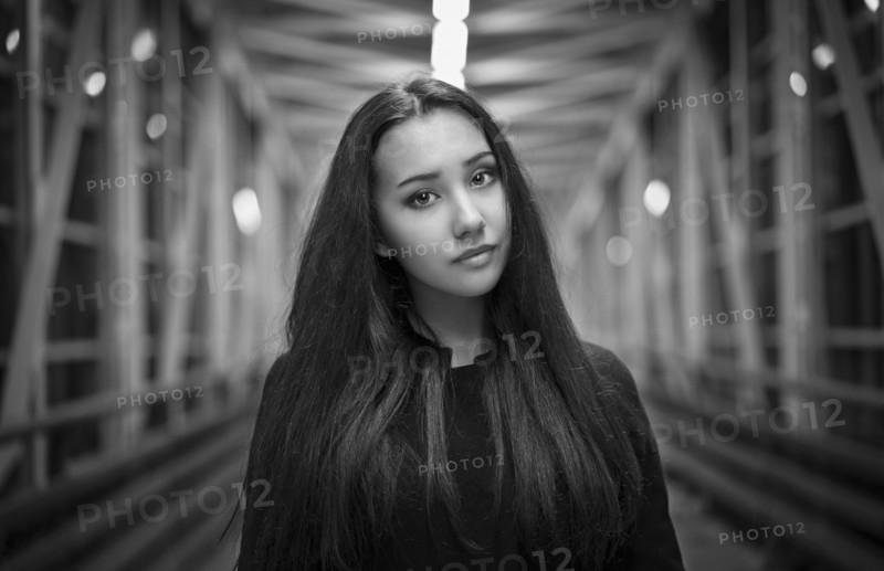 Portrait of serious Mixed Race teenage girl on footbridge
