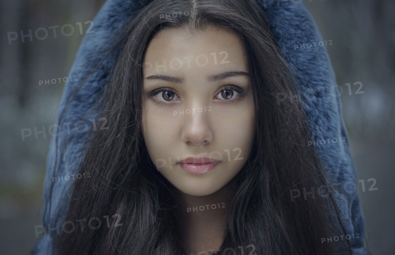 Portrait of serious Mixed Race teenage girl wearing blue hood