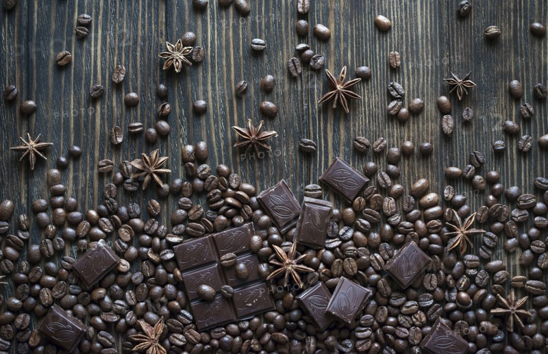 Cocoa beans and chocolate bars on wooden table