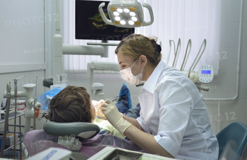 Dentist treating boy