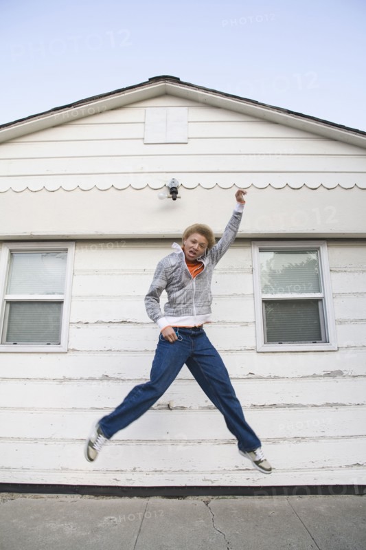 Mixed race boy jumping in mid-air