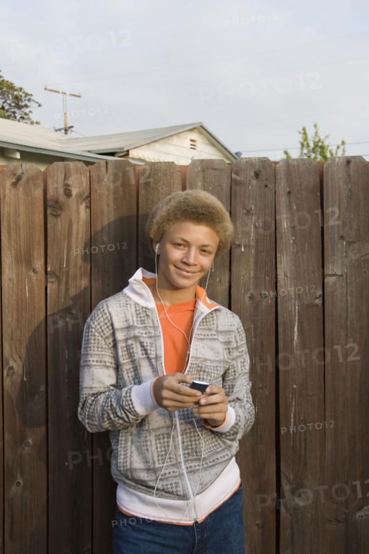 Mixed race boy listening to mp3 player