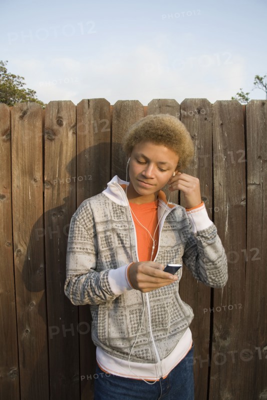 Mixed race boy listening to mp3 player
