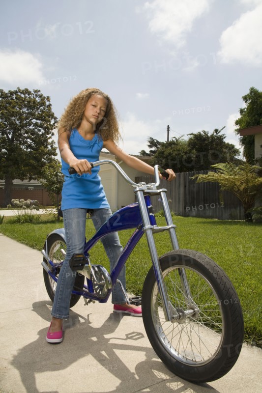 Mixed race girl on bicycle