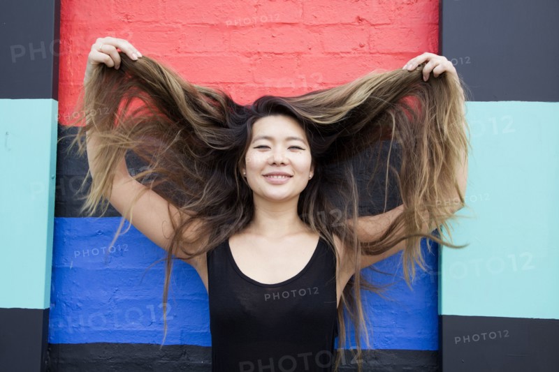 Asian woman playing with hair