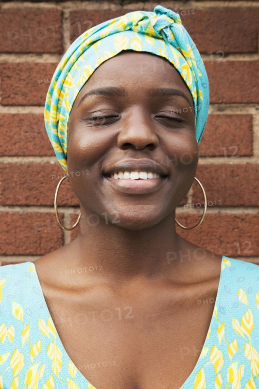 Portrait of smiling Black woman with eyes closed