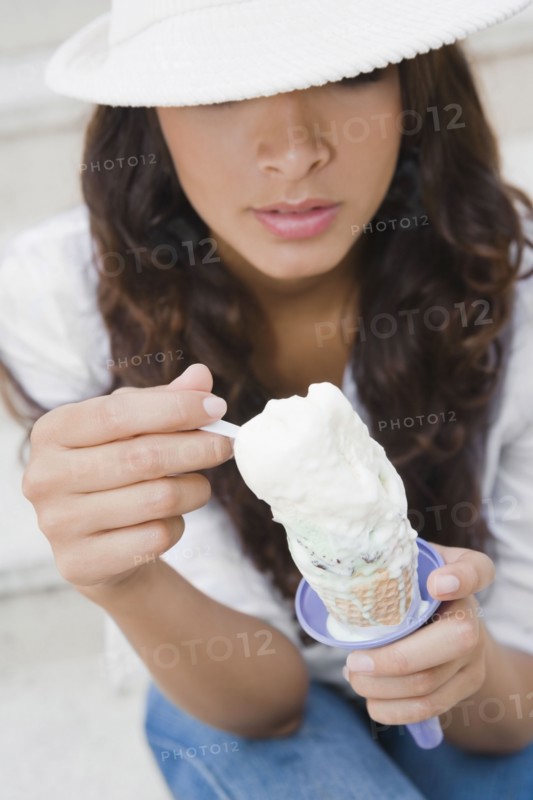 Hispanic woman eating ice cream cone