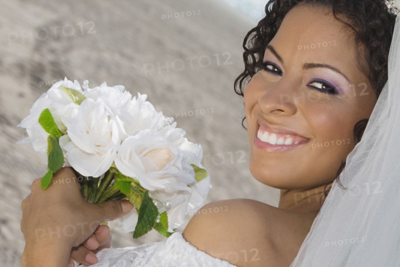 Hispanic bride holding bouquet