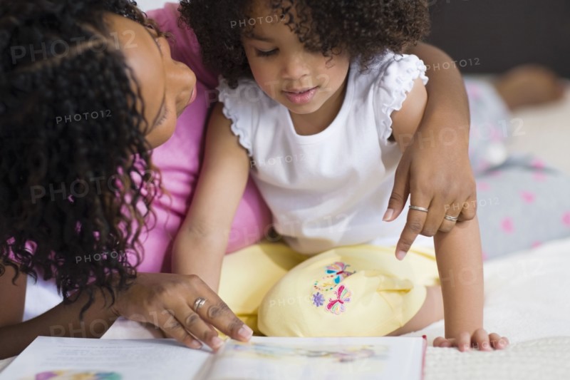African mother reading to daughter