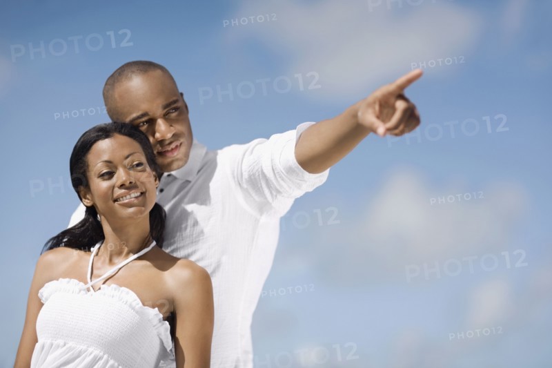 African man pointing for girlfriend