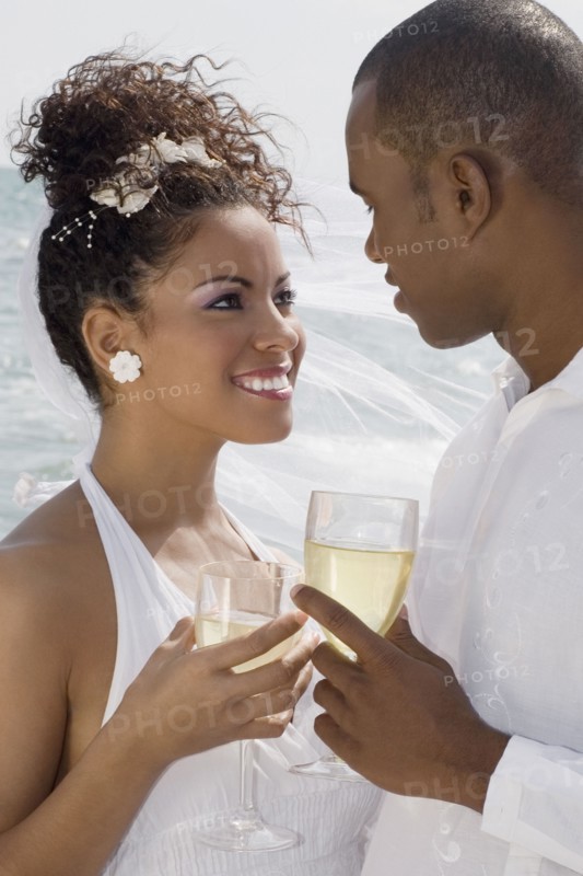 Multi-ethnic bride and groom smiling at each other