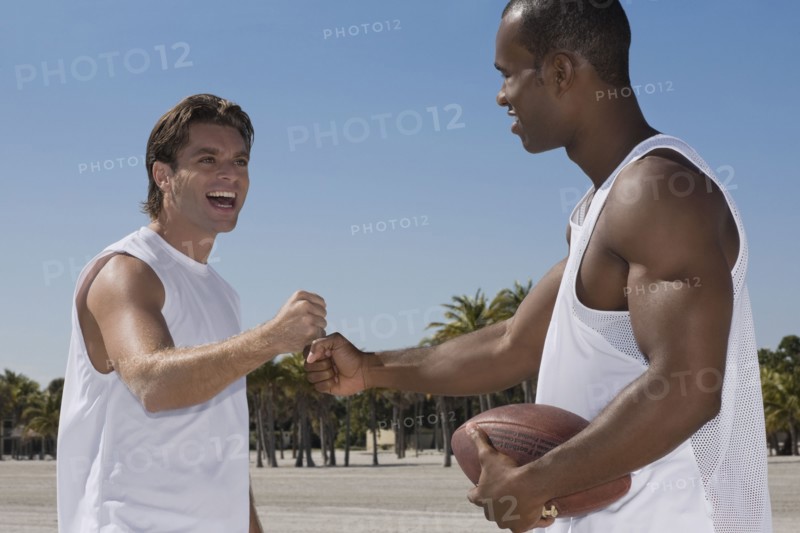 Multi-ethnic men pounding fists