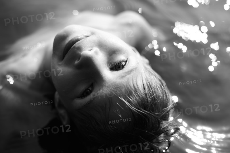 Caucasian boy swimming in water