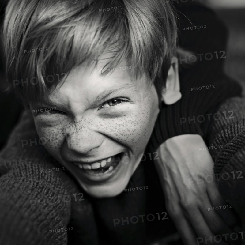 Caucasian boy with freckles laughing
