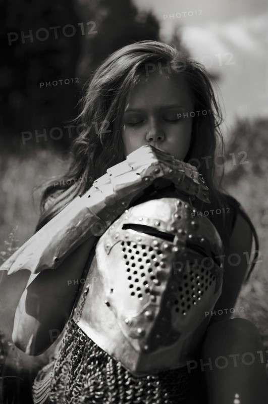 Caucasian girl carrying armor outdoors