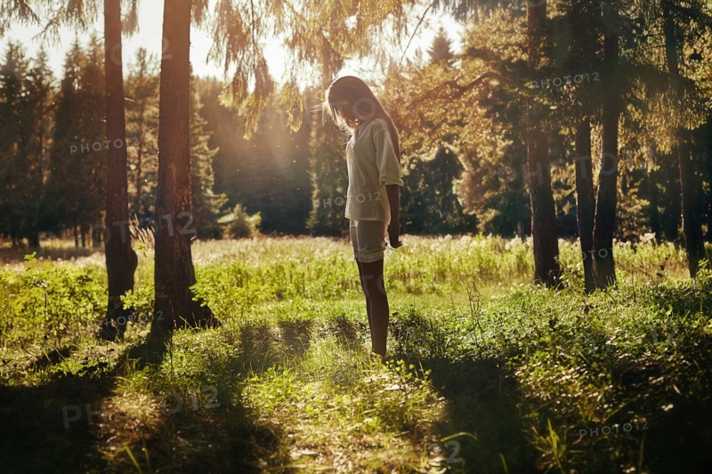 Caucasian girl walking in forest