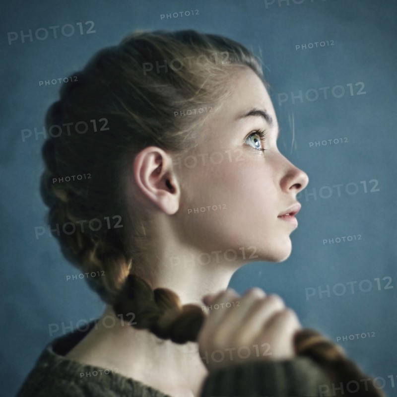 Teenage girl holding braid