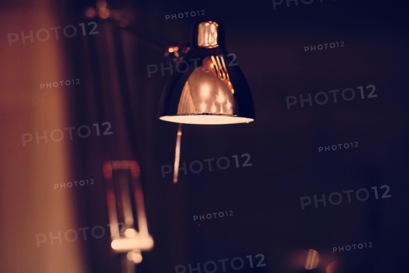 Close up of illuminated desk lamp at night